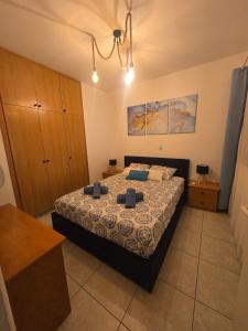 a bedroom with a bed with blue pillows on it at Dailon Oasis in Peyia +17 photos