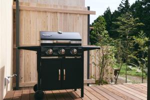 a barbecue grill on a deck with a fence at GEOSPOT Motohakone A 2025年10月 New Open in Hakone