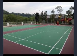 a tennis court with a playground with a slide at MAHEER HOMESTAY Puncak Alam in Bandar Puncak Alam