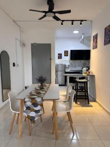 a dining room and kitchen with a table and chairs at MAHEER HOMESTAY Puncak Alam in Bandar Puncak Alam