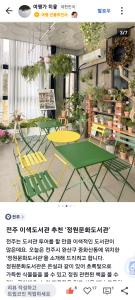 Un cartel de una tienda con sillas y plantas. en sunset, en Jeonju