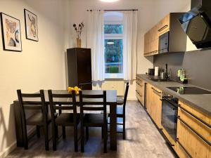 a kitchen with a table and chairs in a kitchen at Eigentumswohnung in Dresden in Dresden +13 photos