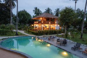a house with a swimming pool in front of a house at COCO Canopy Boutique Resort in Ko Jum