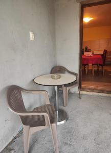 a table and chairs in a room with a table at Rola smeštaj in Paraćin