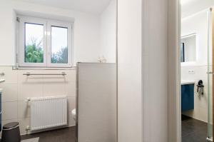 a bathroom with a refrigerator and a window at Fewo Walk in Salem +20 photos