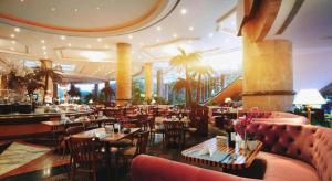 a restaurant with tables and chairs and a bar at Grand Metropark Hotel Nanjing in Nanjing