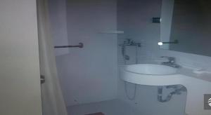 a white bathroom with a sink and a mirror at Jinjiang Inn Wuhu High-Speed Railway Station West Square in Wuhu +170 photos