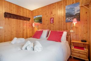 a bedroom with a large bed with red and white pillows at La Baita Verde in Motta
