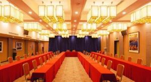 a conference room with red tables and chairs at Guangzhou Rongjin hotel in Guangzhou