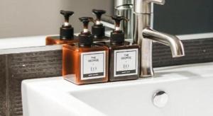 two bottles of soap sitting on a bathroom sink at The George Montclair in Montclair +76 photos