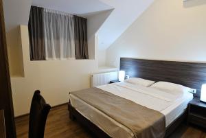 Postel nebo postele na pokoji v ubytování MGK Hotel