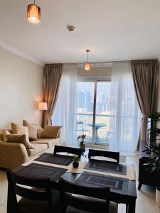 a living room with a couch and a table at Greens in Dubai