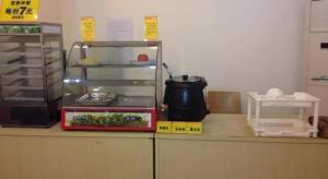 a kitchen counter with an open refrigerator with a scale at 7 Days Inn·Zhuzhou Railway Station Gongxiao Plaza in Zhuzhou +40 photos