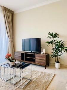 a living room with a flat screen tv on a entertainment center at Greens in Dubai