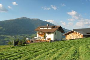 a house sitting on top of a green field at Spisserhof in Chiusa