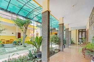 an indoor garden with plants in a building at Collection O 90693 ORCHID EDOTEL Boyolangu in Tulungagung