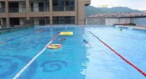 a large swimming pool with two lanes in the water at Taiyi International Hotel in Ch'a-shan-chieh