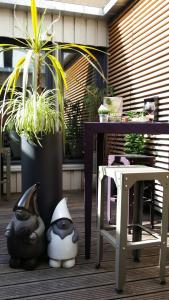 eine Terrasse mit einem Tisch, einem Tisch und Pflanzen in der Unterkunft Campanile Nancy Centre - Gare in Nancy