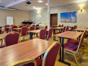 a dining room with wooden tables and chairs at Hotel Topaz Poznań Centrum in Poznań