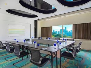 a conference room with a long table and chairs at Blue Sky Hotel Petamburan in Jakarta +119 photos
