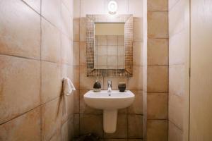 a bathroom with a sink and a mirror at Riglia Villas - Villa Stone in Riglia