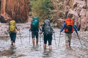 a group of people walking through a river at Nathaliya Home Stay For Backpackers in Negombo