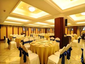 a banquet hall with white tables and chairs at Chengdu French Theme Gold Palace in Chengdu