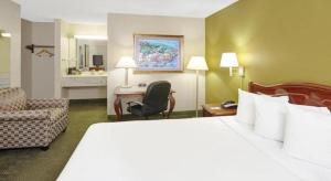 a hotel room with a large bed and a chair at Chicago Lake Shore Hotel in Chicago +17 photos