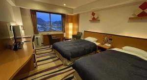 a hotel room with two beds and a window at Gifu Grand Hotel in Gifu +263 photos