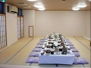 a long table in a room with purple tables at Kinugawa Niouson Plaza Hotel in Nikko