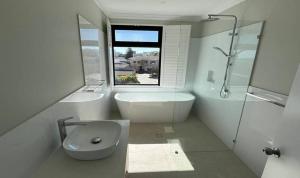 a bathroom with a tub and a toilet and a sink at Beach House Perth in Perth +18 photos