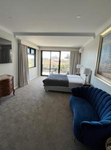 a large bedroom with a bed and a couch at Beach House Perth in Perth