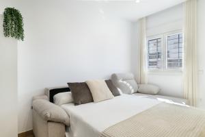 Un ou plusieurs lits dans un hébergement de l'établissement Apartamento Calderon