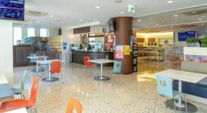 a restaurant with tables and chairs in a cafeteria at Ou Hotel in Yonago
