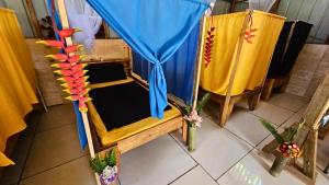 an overhead view of a bed with a blue canopy at Kelly's Mountain Honey Homestay in Goroka