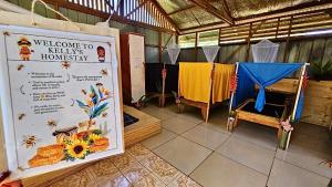 a room with a welcome to kelly homestead with a sign at Kelly's Mountain Honey Homestay in Goroka +31 photos