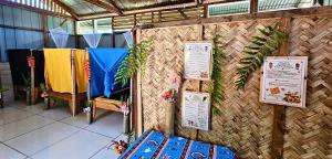 a room with a wall with signs on it at Kelly's Mountain Honey Homestay in Goroka