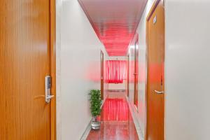 a hallway with red carpeting and a red ceiling at Heavens Inn Near Rasoolpura metro station in Secunderabad