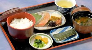 a tray with plates of food and bowls of soup at Alpha Hotel Tokushima in Nishi-shimmachi
