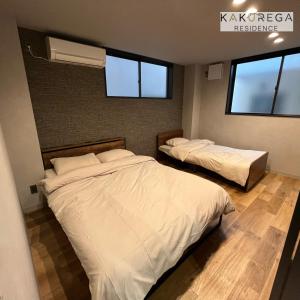 Ένα ή περισσότερα κρεβάτια σε δωμάτιο στο kakurega residence