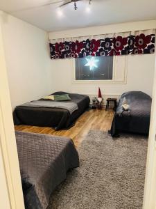 a bedroom with two beds and a window at Cozy apartment in Rovaniemi! in Rovaniemi +12 photos