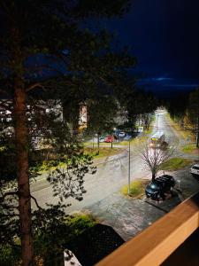 a view from a window of a street at night at Cozy apartment in Rovaniemi! in Rovaniemi
