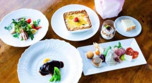 four plates of food on a wooden table at WISTERIAN LIFE CLUB Nojiriko in Kashiwabara