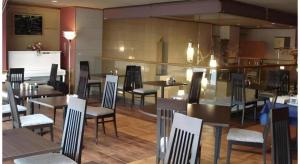 a dining room with tables and chairs in a restaurant at Mimatsu Hotel in Mito
