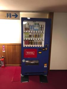 a blue vending machine with drinks in a room at HotelNewYama in Nagano