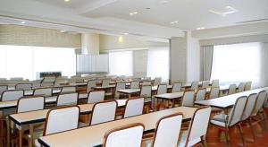 an empty classroom with tables and white chairs at Ikebukuro Royal Hotel in Tokyo +96 photos