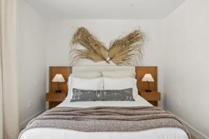 a bedroom with a large bed with two lamps at Tide House - Unit B - Modern Seaside 1BD w Parking in El Segundo