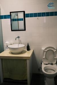 a bathroom with a sink and a toilet and a mirror at City-Center Heritage Getaway for 12 Pax in George Town +19 photos