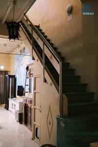 a staircase in a building with a green stair railing at City-Center Heritage Getaway for 12 Pax in George Town
