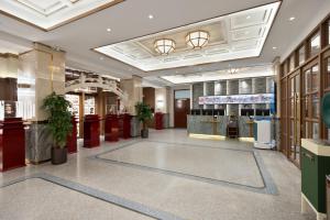 a lobby of a store with a reception counter at Nostalgia S Hotel Beijing Qianmen Street & Tianqiao Performing Arts Center 时光漫步S酒店 北京前门天桥艺术中心店 Free fresh ground coffee,Free laundry service in Beijing